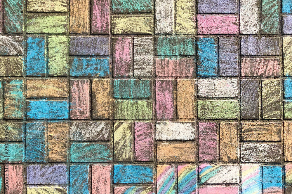 Fototapeta premium street tile decorated with the pieces of colorful chalk for kids, texture