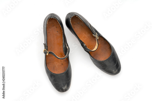 pair of old black women's shoes, isolated on white