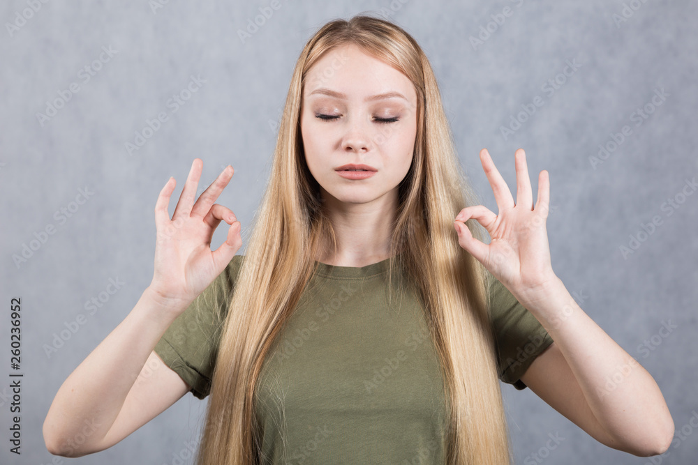 Young beautiful woman shows ok sign. Body language concept. Young beautiful woman shows ok sign. Body language concept.