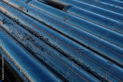 Pipe metal texture. Drillpipe on Oil Rig Pipe Deck. Rusty drill pipes were drilled in the well section.