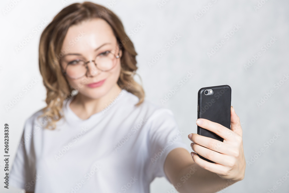Beautiful young woman taking selfie on smartphone. Beautiful young woman taking selfie on smartphone.