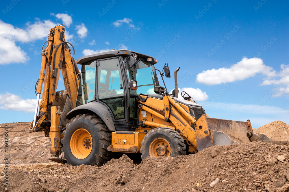 Excavator works under blue sky Excavator works under blue sky
