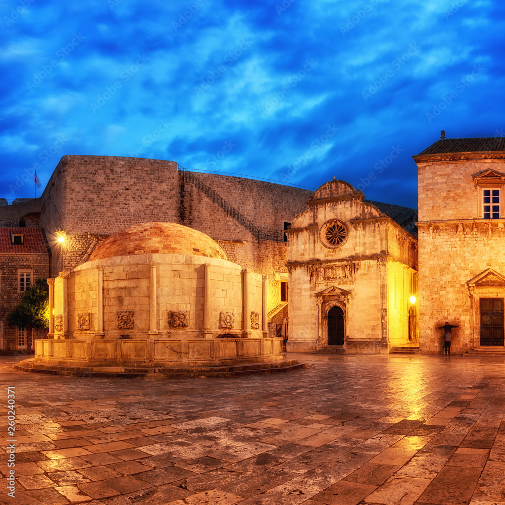 Old City of Dubrovnik, historical town square with big Onofrio fountain, church and the entrance to the city wall, UNESCO World Heritage site, Croatia, travel background