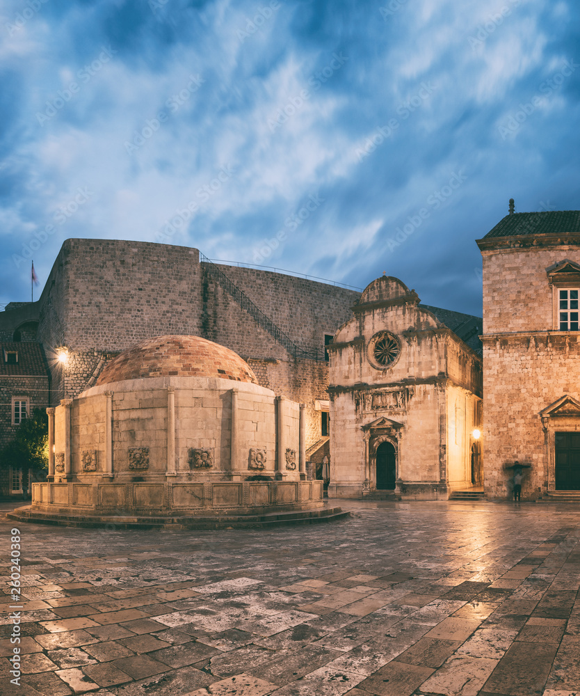 Old City of Dubrovnik, historical town square with big Onofrio fountain, church and the entrance to the city wall, UNESCO World Heritage site, Croatia, travel background