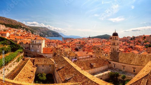 Old City of Dubrovnik red roofs and Franciscan monastery, panoramic view from ancient city wall. World famous and most visited historic city of Croatia, UNESCO World Heritage site, travel background