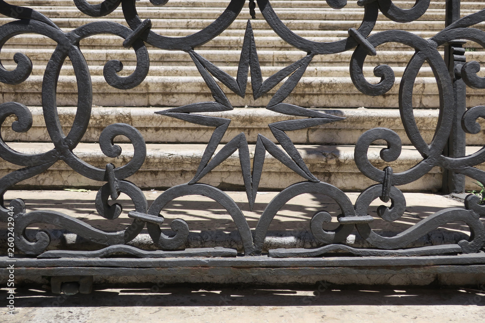 image of an star made of cast iron in front of stone stairs in Malaga