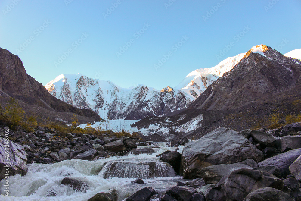 The river flowing from the glacier near the snow-white mountains