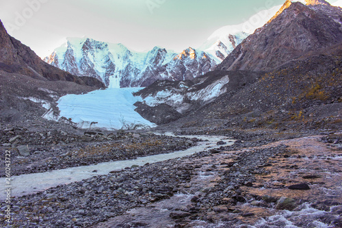 The river flowing from the glacier near the snow-white mountains