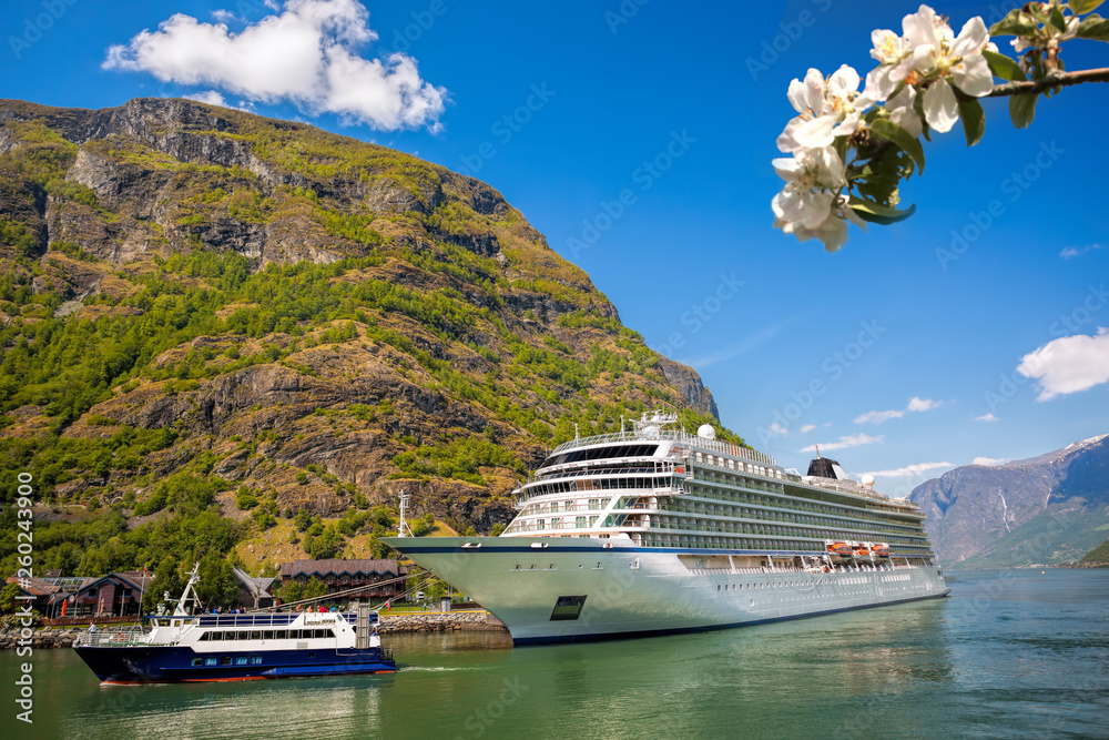 Flam village with ship in harbor against fjord during spring time, Norway Flam village with ship in harbor against fjord during spring time, Norway