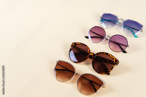 Set of female sunglasses on yellow background. Optic shop banner. Copy space.