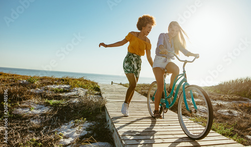 Friends enjoying themselves with a bicycle