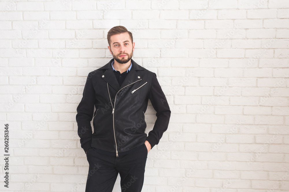 Young stylish man in black jacket on white background. Young stylish man in black jacket on white background.