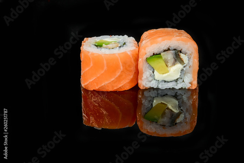 traditional fresh japanese sushi rolls on a black background