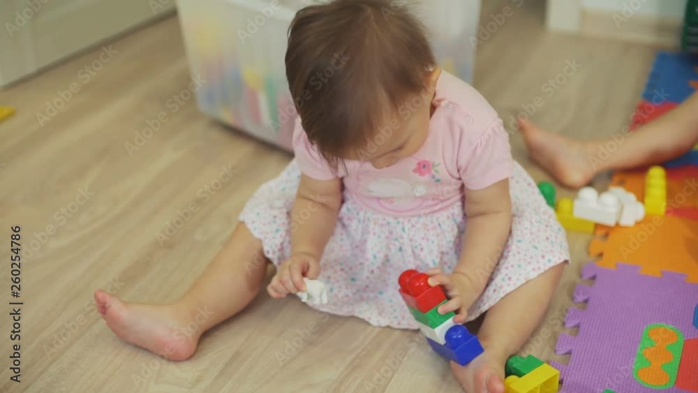 Cute Little Girl Playing with Blocks and Toy Bear Cute Little Girl Playing with Blocks and Toy Bear
