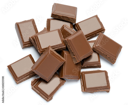 Milk organic chocolate pieces isolated on white background