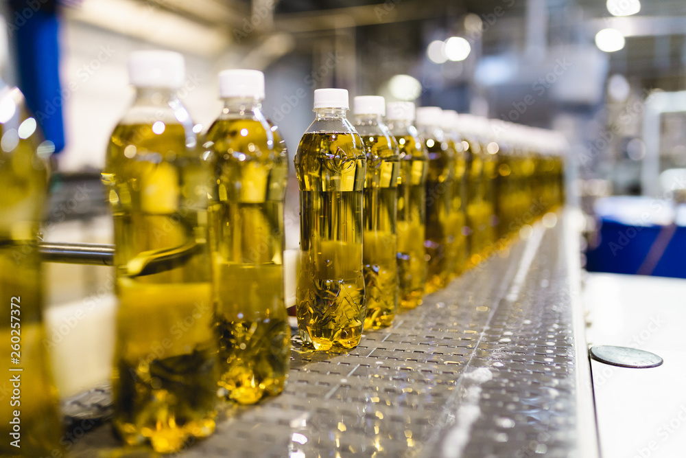 Bottling factory - Apple juice bottling line for processing and bottling juice into bottles. Selective focus. . Bottling factory - Apple juice bottling line for processing and bottling juice into bottles. Selective focus. .