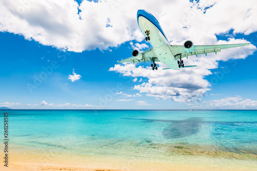 Fototapeta Naklejka Na Ścianę i Meble -  Passenger airplane above Maho beach in St Maarten, Caribbean. Travel and air transportation background.