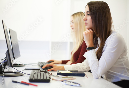 Two female colleagues in office working together. Two female colleagues in office working together