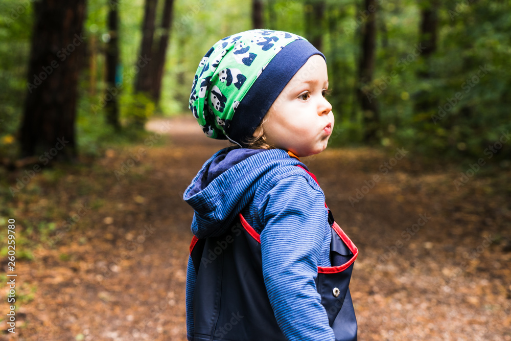 baby playing on a forest path in autumn baby playing on a forest path in autumn