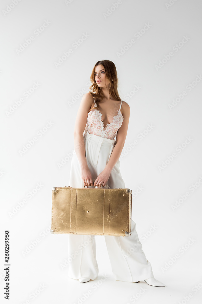 stylish pretty girl holding suitcase while standing on white stylish pretty girl holding suitcase while standing on white