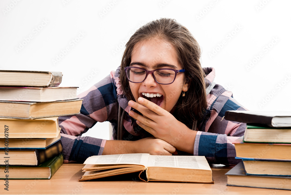 Girl with books. exams at school. student is sitting at the table with books. Education. Printed books, study at school. Library. Girl with books. exams at school. student is sitting at the table with books. Education. Printed books, study at school. Library.