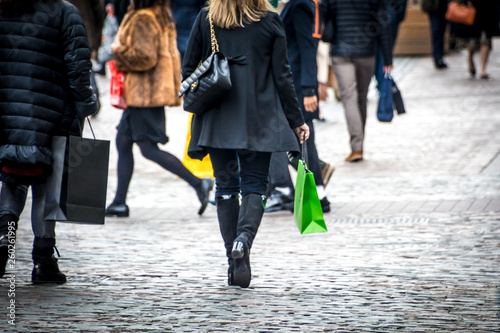 Busy street scene with shopping bags © William