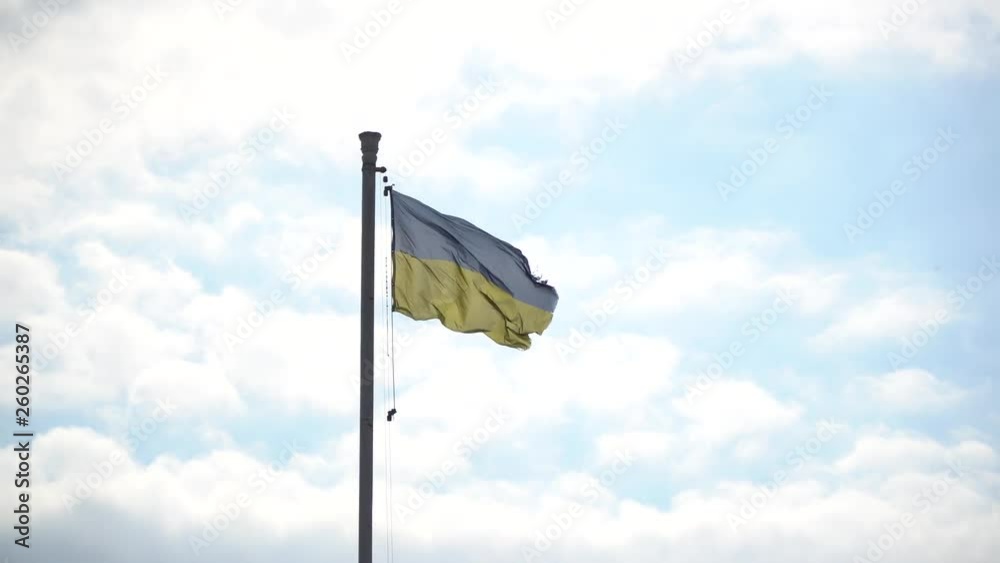 Flag of Ukraine. against blue sky, flag installed on flagpole in Kyiv Flag of Ukraine. against blue sky, flag installed on flagpole in Kyiv