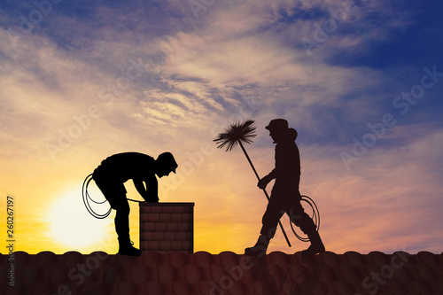 Photo illustration of chimney sweep on the roof at sunset