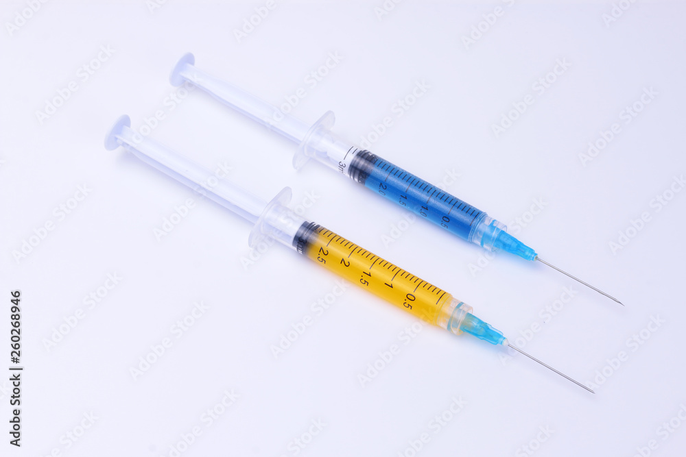 Syringes. Syringes with yellow and blue liquid inside. Syringes. Syringes with yellow and blue liquid inside.