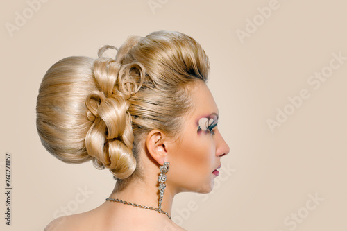 Beautiful bride with fashion wedding hairstyle on background peach shade yellow