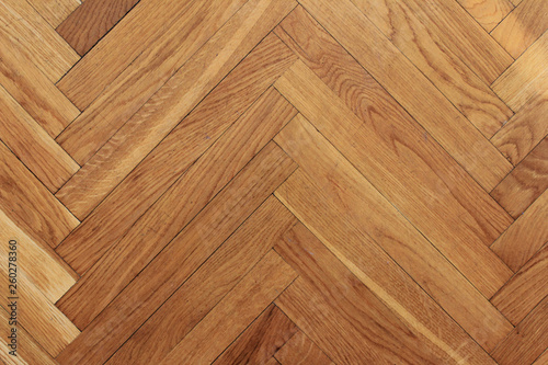 Parquet floor wooden pattern background of old timber hardwood texture in apartment living room. Home decor element of simple interior design with empty brown laminate top view