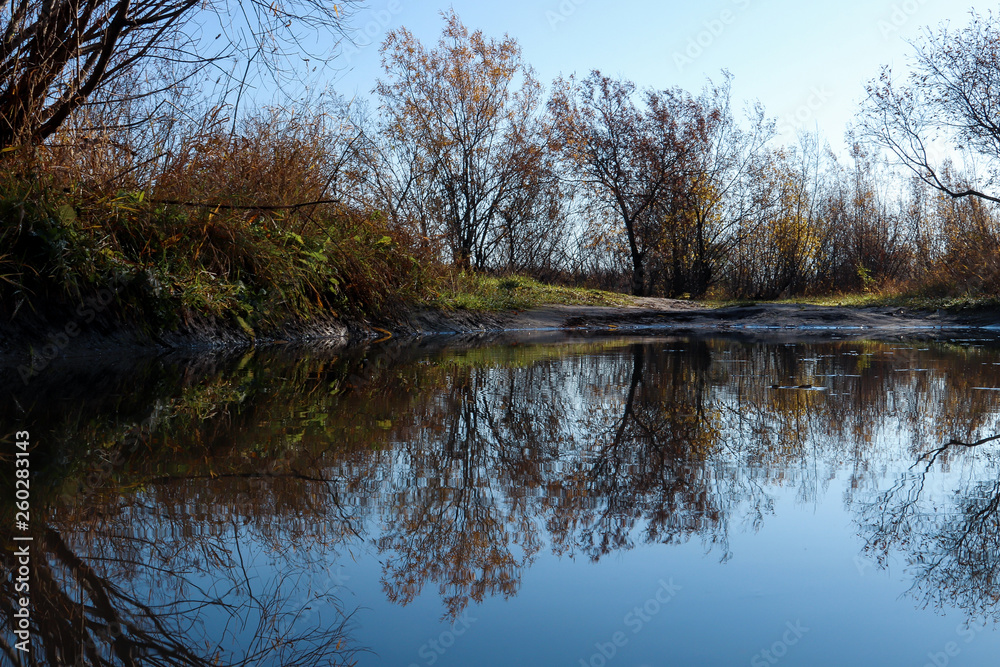 Autumn day in Arkhangelsk. Island Krasnoflotsky. the reflection in the water