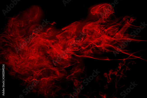 Abstract red smoke on black background. Dramatic red smoke clouds. Movement of colorful smoke.
