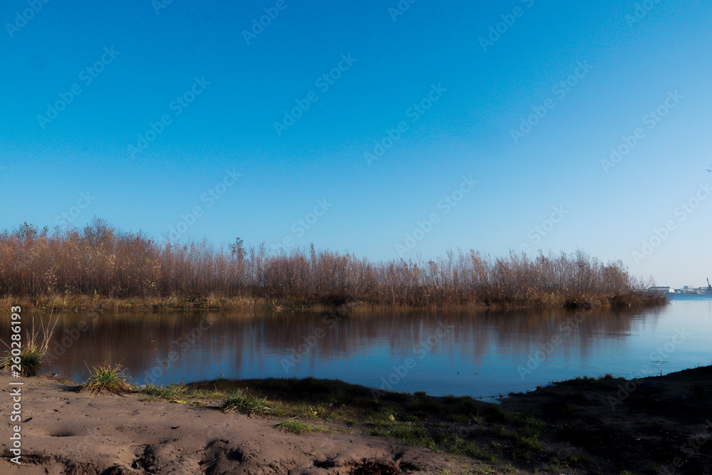 Autumn day in Arkhangelsk. Island Krasnoflotsky. the reflection in the water