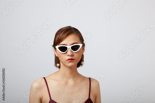 Chinese Girl wearing varies types of fashion sunglasses,looking sharp