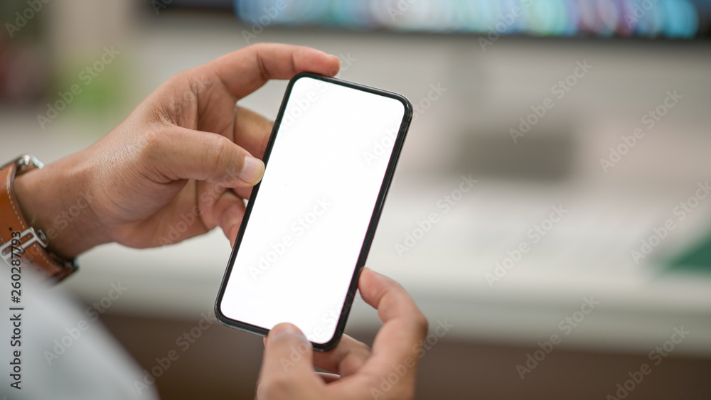 Business man showing blank screen mobile phone in office