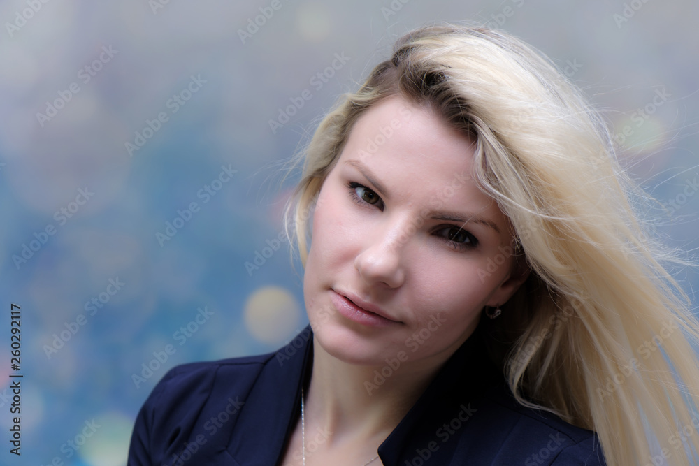Portrait of happy smiling young cheerful businesswoman standing with flowing hair. Success in business concept studio shot. Blue suit. Multicolor wall background. Portrait of happy smiling young cheerful businesswoman standing with flowing hair. Success in business concept studio shot. Blue suit. Multicolor wall background.