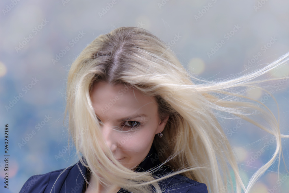 Portrait of happy smiling young cheerful businesswoman standing with flowing hair. Success in business concept studio shot. Blue suit. Multicolor wall background. Portrait of happy smiling young cheerful businesswoman standing with flowing hair. Success in business concept studio shot. Blue suit. Multicolor wall background.