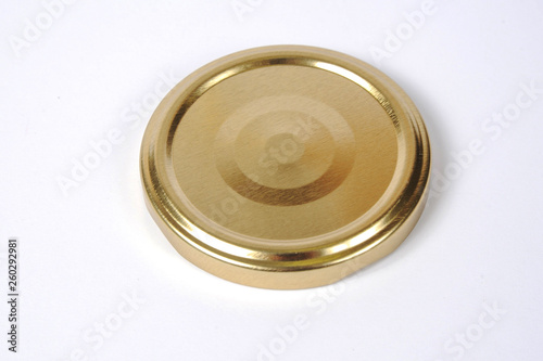 Screw cap for glass jars. For canning, canned food. Golden cap on white background