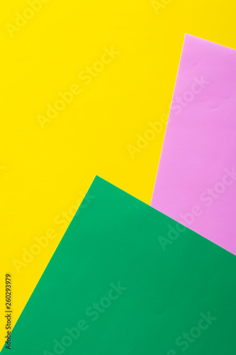 Multicolored vertical background, colored cardboard. Yellow, green and purple. Copy space