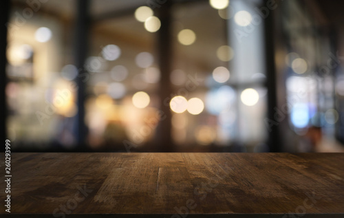 Empty dark wooden table in front of abstract blurred bokeh background of restaurant . can be used for display or montage your products.Mock up for space.