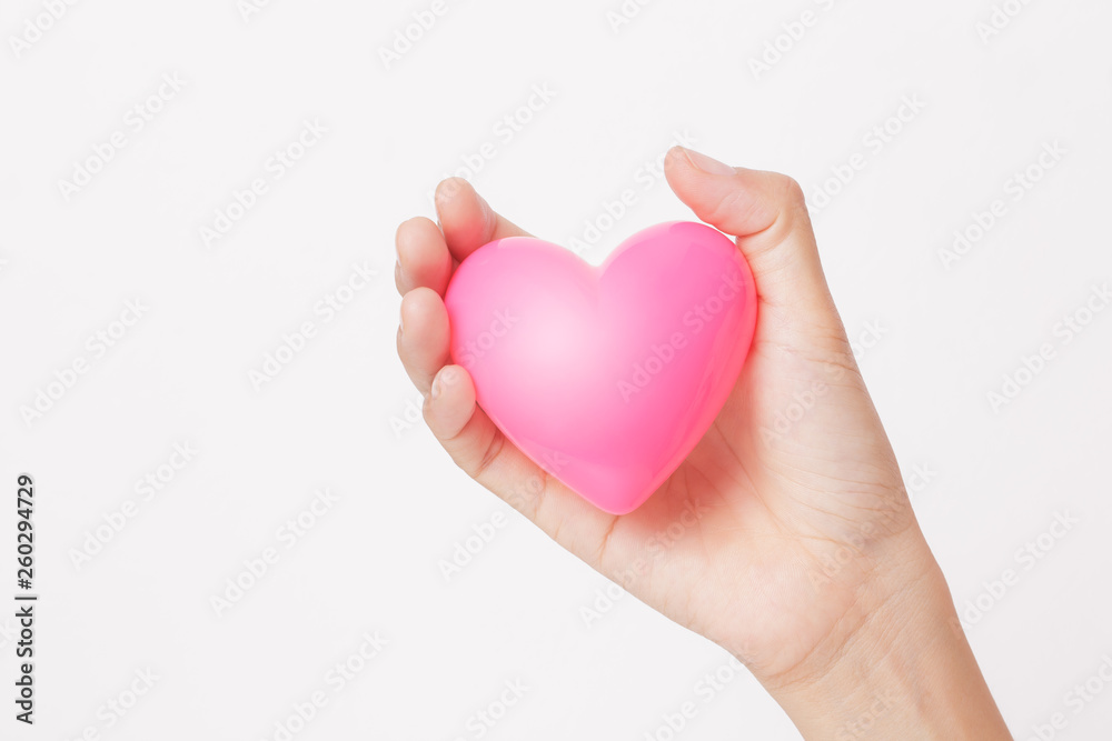 Female hands giving pink heart for love symbol sign on white background Female hands giving pink heart for love symbol sign on white background