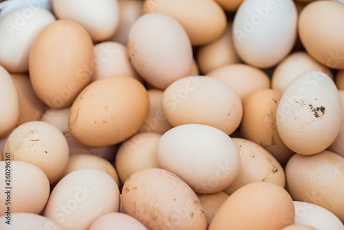 Lots of raw chicken eggs background close up