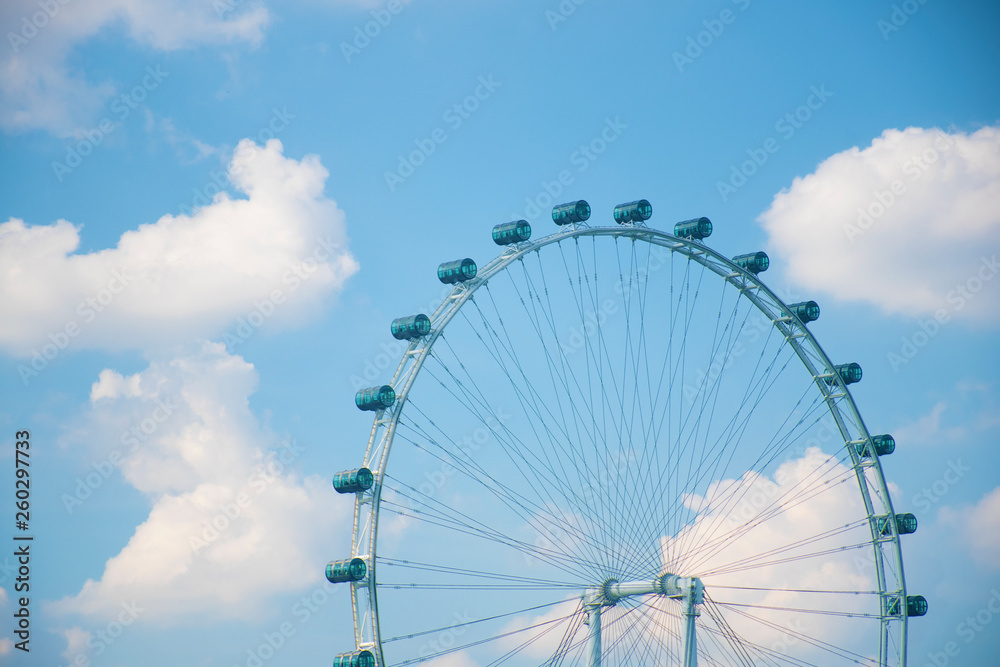 Fototapeta premium Ferrist wheel with beautiful blue sky in day light in amusement park in Singapore.