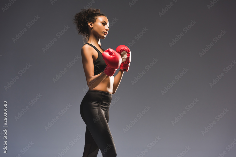 beautiful athletic african american sportswoman in boxing gloves isolated on black with copy space beautiful athletic african american sportswoman in boxing gloves isolated on black with copy space