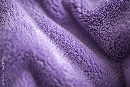 Lilac delicate soft background of fur plush smooth fabric. Texture of purple soft fleecy blanket textile