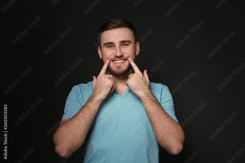 Man showing LAUGH gesture in sign language on black background Man showing LAUGH gesture in sign language on black background