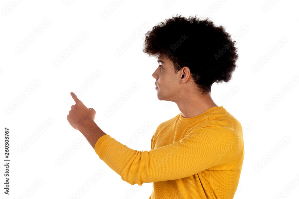 Afro teenager with yellow t-shirt pointing something with his finger Afro teenager with yellow t-shirt pointing something with his finger