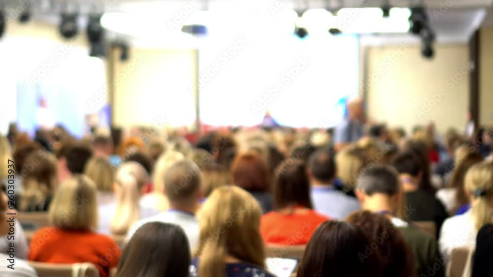 he woman with the smartphone in hands. People at a conference. Beautiful view.