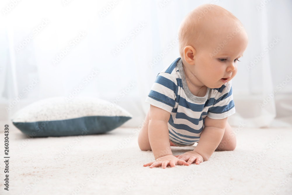 Cute little baby crawling on carpet indoors, space for text Cute little baby crawling on carpet indoors, space for text